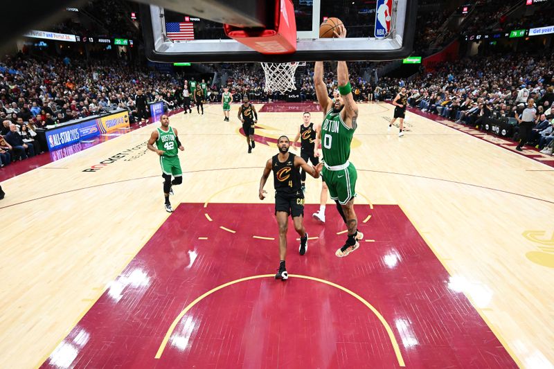 CLEVELAND, OHIO - FEBRUARY 04: Jayson Tatum #0 of the Boston Celtics dunks over Evan Mobley #4 of the Cleveland Cavaliers during the third quarter at Rocket Mortgage Fieldhouse on February 04, 2025 in Cleveland, Ohio. The Celtics defeated the Cavaliers 112-105. NOTE TO USER: User expressly acknowledges and agrees that, by downloading and or using this photograph, User is consenting to the terms and conditions of the Getty Images License Agreement. (Photo by Jason Miller/Getty Images)