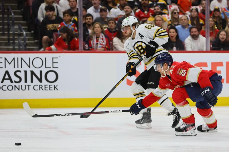 May 6, 2024; Sunrise, Florida, USA; Boston Bruins right wing David Pastrnak (88) moves the puck past Florida Panthers defenseman Gustav Forsling (42) during the first period in game one of the second round of the 2024 Stanley Cup Playoffs at Amerant Bank Arena. Mandatory Credit: Sam Navarro-USA TODAY Sports