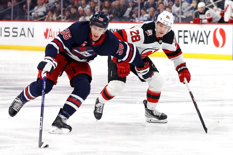 Apr 2, 2023; Winnipeg, Manitoba, CAN; Winnipeg Jets center Morgan Barron (36) is chased down by New Jersey Devils defenseman Damon Severson (28) in the second period at Canada Life Centre. Mandatory Credit: James Carey Lauder-USA TODAY Sports