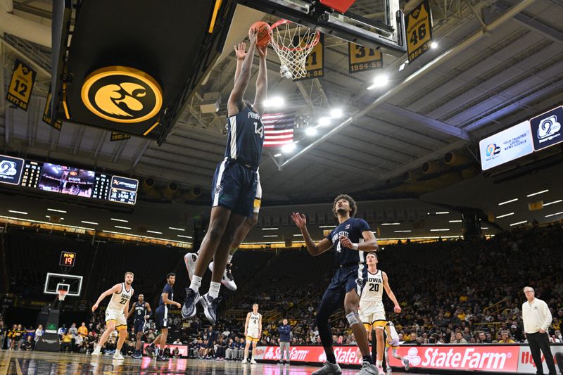 Feb 27, 2024; Iowa City, Iowa, USA; Penn State Nittany Lions forward Demetrius Lilley (14) goes to the basket as Iowa Hawkeyes guard Tony Perkins (11) defends and head coach Fran McCaffery looks on during the first half at Carver-Hawkeye Arena. Mandatory Credit: Jeffrey Becker-USA TODAY Sports