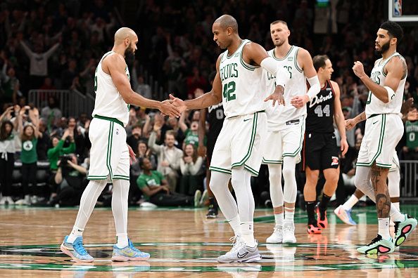 BOSTON, MASSACHUSETTS - DECEMBER 28: Derrick White #9 high-fives Al Horford #42 of the Boston Celtics after making a three-point basket against the Detroit Pistons during overtime at TD Garden on December 28, 2023 in Boston, Massachusetts. NOTE TO USER: User expressly acknowledges and agrees that, by downloading and or using this photograph, User is consenting to the terms and conditions of the Getty Images License Agreement. (Photo by Brian Fluharty/Getty Images)