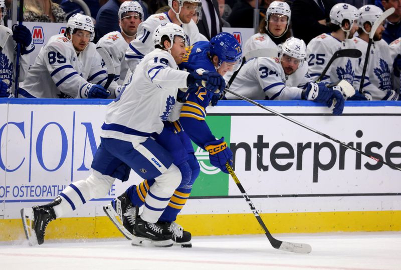 Dec 21, 2023; Buffalo, New York, USA;  Buffalo Sabres right wing Tage Thompson (72) hits Toronto Maple Leafs right wing Mitchell Marner (16) as they go after a loose puck during the third period at KeyBank Center. Mandatory Credit: Timothy T. Ludwig-USA TODAY Sports