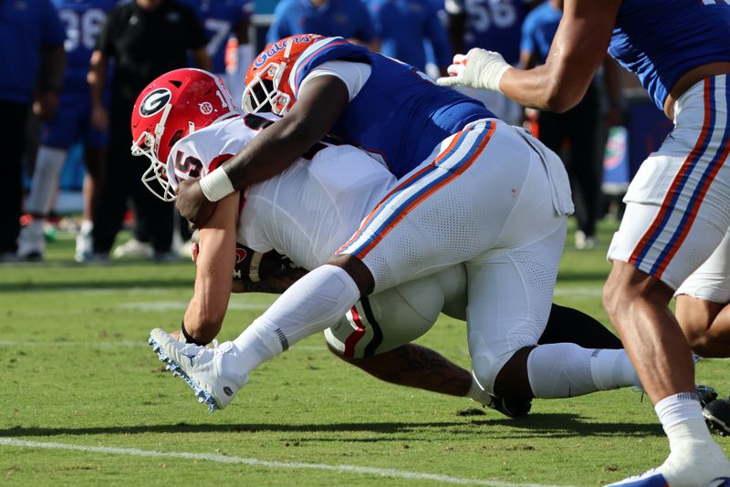 Oct 28, 2023; Jacksonville, Florida, USA; Florida Gators defensive lineman Jamari Lyons (95) tackles Georgia Bulldogs quarterback Carson Beck (15) during the first half at EverBank Stadium. Mandatory Credit: Kim Klement Neitzel-USA TODAY Sports