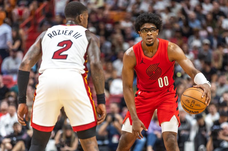 MIAMI, FLORIDA - MARCH 29: Scoot Henderson #00 of the Portland Trail Blazers in action against Terry Rosier III #2 of the Miami Heat	 during the first half at the Kaseya Center on March 29, 2024 in Miami, Florida. NOTE TO USER: User expressly acknowledges and agrees that, by downloading and or using this photograph, User is consenting to the terms and conditions of the Getty Images License Agreement.  (Photo by Lauren Sopourn/Getty Images)