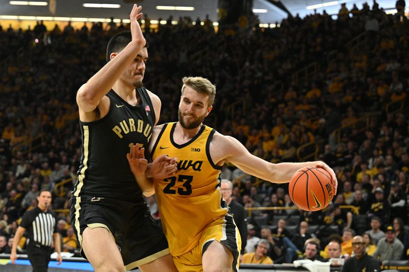 Jan 20, 2024; Iowa City, Iowa, USA; Iowa Hawkeyes forward Ben Krikke (23) attempts to go to the basket against Purdue Boilermakers center Zach Edey (15) during the second half at Carver-Hawkeye Arena. Mandatory Credit: Jeffrey Becker-USA TODAY Sports