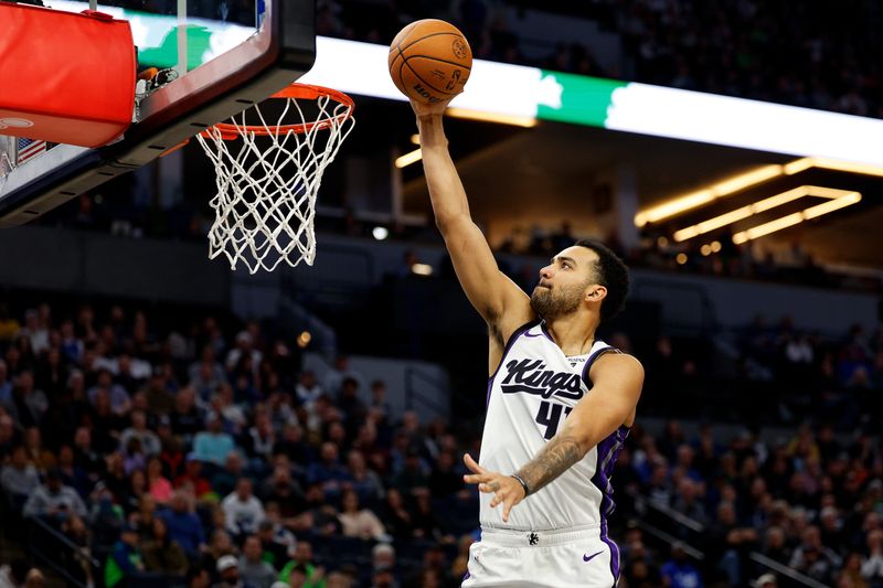 MINNEAPOLIS, MINNESOTA - MARCH 01: Trey Lyles #41 of the Sacramento Kings dunks the ball against the Minnesota Timberwolves in the first quarter at Target Center on March 01, 2024 in Minneapolis, Minnesota. NOTE TO USER: User expressly acknowledges and agrees that, by downloading and or using this photograph, User is consenting to the terms and conditions of the Getty Images License Agreement. (Photo by David Berding/Getty Images)