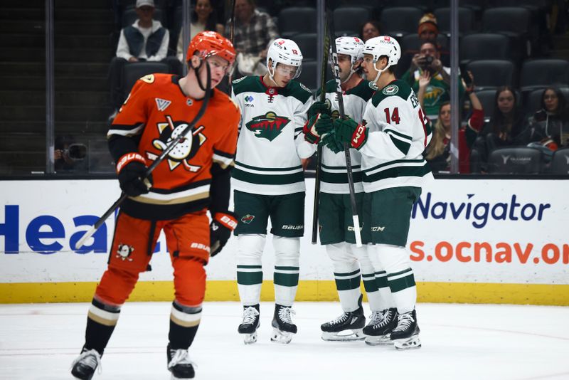 Nov 8, 2024; Anaheim, California, USA; Minnesota Wild defenseman Jake Middleton (5) celebrates with his teammates after a goal during the first period of a hockey game against the Anaheim Ducks at Honda Center. Mandatory Credit: Jessica Alcheh-Imagn Images