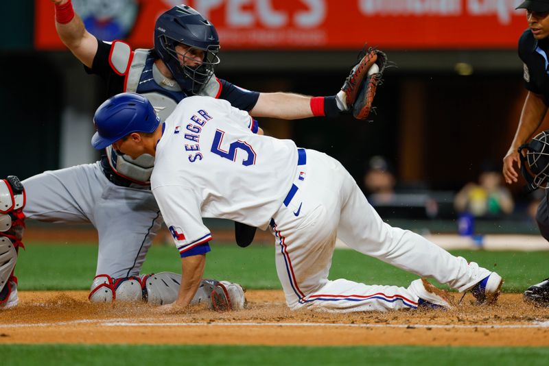 May 15, 2024; Arlington, Texas, USA; Cleveland Guardians catcher Austin Hedges (27) tags Texas Rangers shortstop Corey Seager (5) out at the plate during the fourth inning at Globe Life Field. Mandatory Credit: Andrew Dieb-USA TODAY Sports