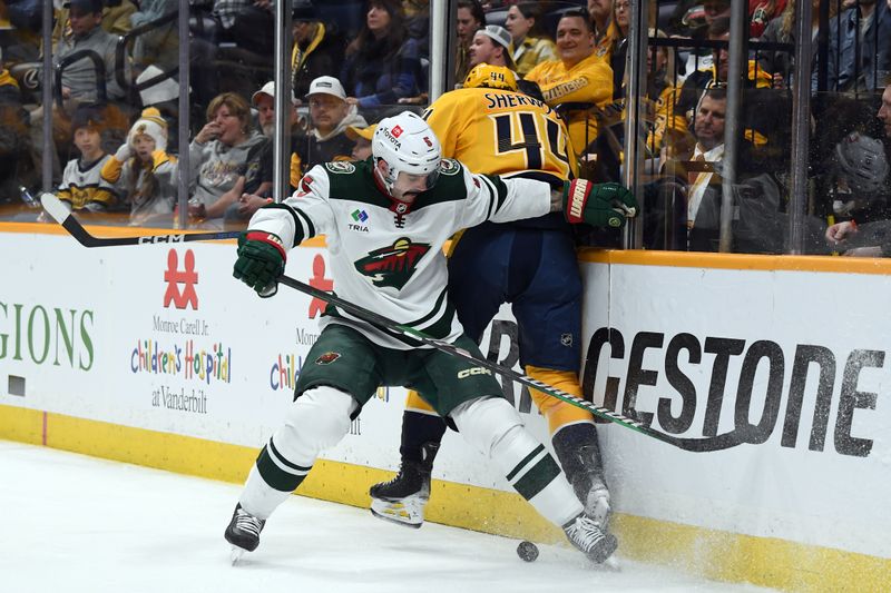 Feb 29, 2024; Nashville, Tennessee, USA; Minnesota Wild defenseman Jake Middleton (5) battles for a loose puck against Nashville Predators left wing Kiefer Sherwood (44) during the third period at Bridgestone Arena. Mandatory Credit: Christopher Hanewinckel-USA TODAY Sports