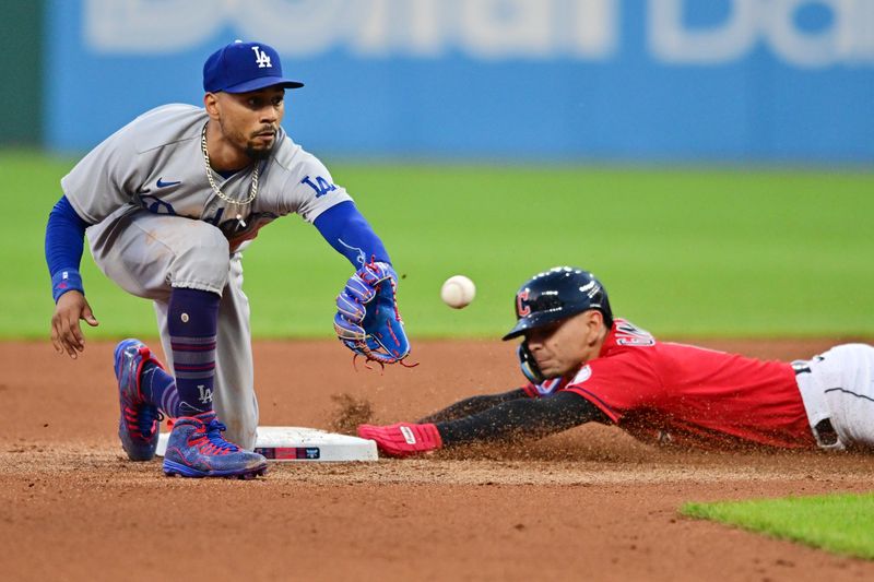 Aug 22, 2023; Cleveland, Ohio, USA; Los Angeles Dodgers second baseman Mookie Betts (50) waits for the throw as Cleveland Guardians second baseman Andres Gimenez (0) steals second during the fourth inning at Progressive Field. Mandatory Credit: Ken Blaze-USA TODAY Sports