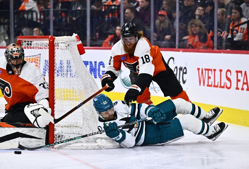 Mar 12, 2024; Philadelphia, Pennsylvania, USA; Philadelphia Flyers defenseman Marc Staal (18) hits San Jose Sharks center Ryan Carpenter (22) as he dives with the puck in the second period at Wells Fargo Center. Mandatory Credit: Kyle Ross-USA TODAY Sports