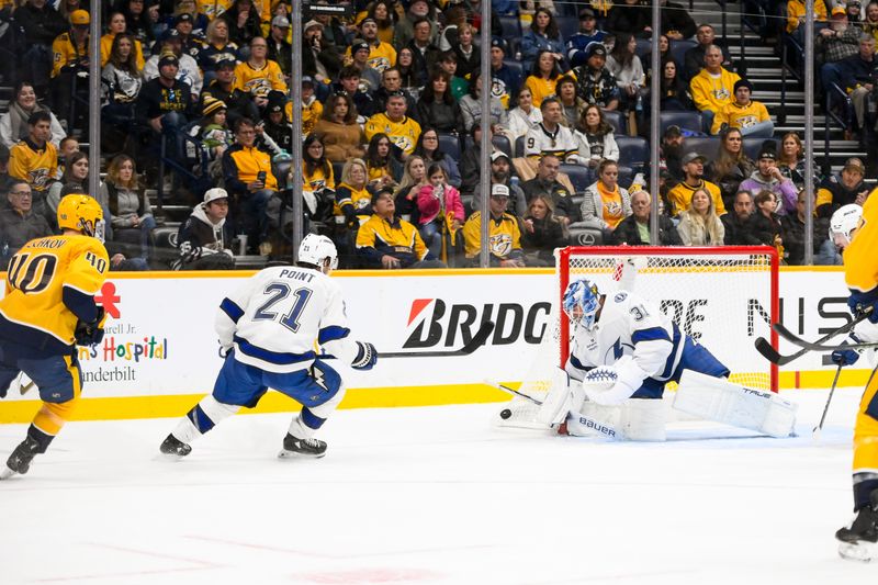 Nov 29, 2024; Nashville, Tennessee, USA;  Tampa Bay Lightning goaltender Jonas Johansson (31) blocks the shot of Nashville Predators center Colton Sissons (10) during the second period at Bridgestone Arena. Mandatory Credit: Steve Roberts-Imagn Images