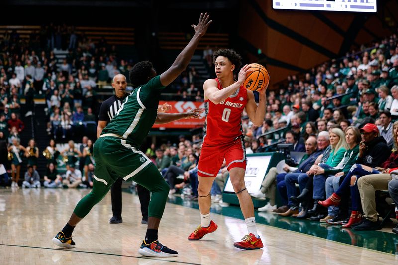 Mar 3, 2023; Fort Collins, Colorado, USA; New Mexico Lobos guard KJ Jenkins (0) controls the ball as Colorado State Rams guard Isaiah Stevens (4) guards in the first half at Moby Arena. Mandatory Credit: Isaiah J. Downing-USA TODAY Sports