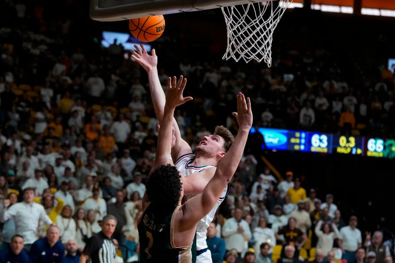 Jan 27, 2024; Laramie, Wyoming, USA; Wyoming Cowboys forward Mason Walters (33) shoots against Colorado State Rams guard Joel Scott (1) during the second half to put the game into overtime at Arena-Auditorium. Mandatory Credit: Troy Babbitt-USA TODAY Sports