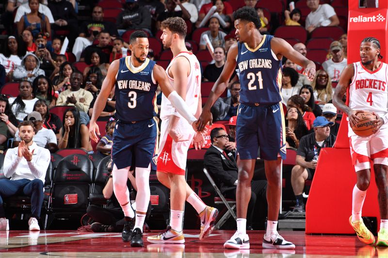 HOUSTON, TX - OCTOBER 15: CJ McCollum #3 and Yves Missi #21 of the New Orleans Pelicans high five during the game against the Houston Rockets during a NBA preseason game on October 15, 2024 at the Toyota Center in Houston, Texas. NOTE TO USER: User expressly acknowledges and agrees that, by downloading and or using this photograph, User is consenting to the terms and conditions of the Getty Images License Agreement. Mandatory Copyright Notice: Copyright 2024 NBAE (Photo by Logan Riely/NBAE via Getty Images)