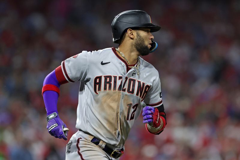 Oct 24, 2023; Philadelphia, Pennsylvania, USA; Arizona Diamondbacks left fielder Lourdes Gurriel Jr. (12) runs to first base after hitting a single against the Philadelphia Phillies in the sixth inning for game seven of the NLCS for the 2023 MLB playoffs at Citizens Bank Park. Mandatory Credit: Bill Streicher-USA TODAY Sports