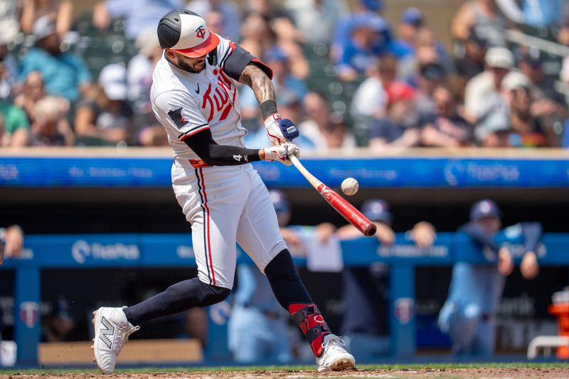 Jun 7, 2025; Minneapolis, Minnesota, USA; Minnesota Twins shortstop Carlos Correa (4) flies out to right field to end the eighth inning off a pitch by Toronto Blue Jays pitcher Chad Green (57) at Target Field. Mandatory Credit: Matt Blewett-Imagn Images