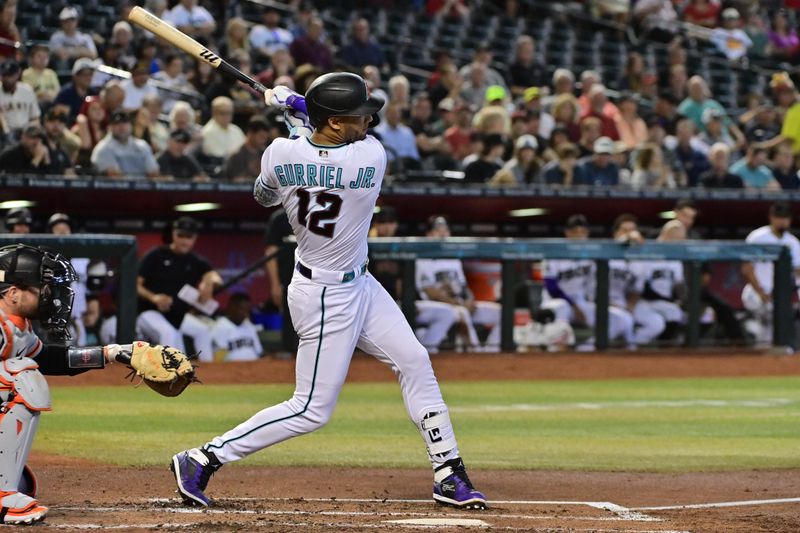 Sep 20, 2023; Phoenix, Arizona, USA;  Arizona Diamondbacks left fielder Lourdes Gurriel Jr. (12) hits a single in the second inning against the San Francisco Giants at Chase Field. Mandatory Credit: Matt Kartozian-USA TODAY Sports