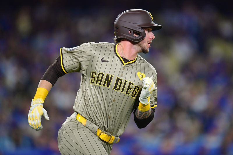 Sep 24, 2024; Los Angeles, California, USA; San Diego Padres center fielder Jackson Merrill (3) runs after hitting a single against the Los Angeles Dodgers during the second inning at Dodger Stadium. Mandatory Credit: Gary A. Vasquez-Imagn Images