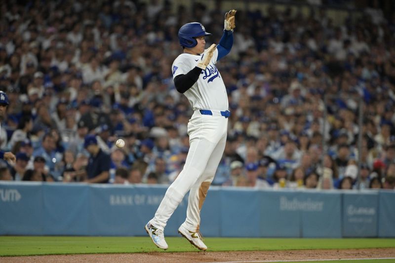 Aug 28, 2024; Los Angeles, California, USA;  Los Angeles Dodgers designated hitter Shohei Ohtani (17) jumps out of the way of a foul ball hit down the third base line by left fielder Teoscar Hernandez (37) in the third inning against the Baltimore Orioles at Dodger Stadium. Mandatory Credit: Jayne Kamin-Oncea-USA TODAY Sports