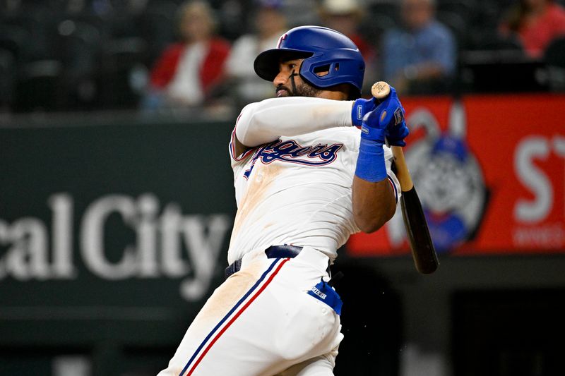 Jun 3, 2024; Arlington, Texas, USA; Texas Rangers first baseman Ezequiel Duran (20) hits a double against the Detroit Tigers during the ninth inning at Globe Life Field. Mandatory Credit: Jerome Miron-USA TODAY Sports