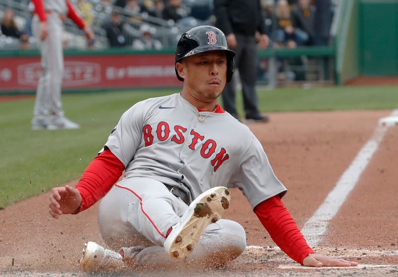 Apr 21, 2024; Pittsburgh, Pennsylvania, USA;  Boston Red Sox right fielder Rob Refsnyder (30) slides home to score a run against the Pittsburgh Pirates during the sixth inning at PNC Park. Boston won 6-1. andatory Credit: Charles LeClaire-USA TODAY Sports