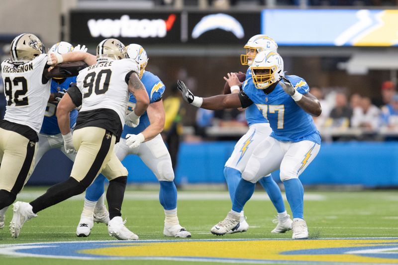 Los Angeles Chargers guard Zion Johnson (77) takes his stance during an NFL preseason football game against the New Orleans Saints, Sunday, Aug. 20, 2023, in Inglewood, Calif. (AP Photo/Kyusung Gong)