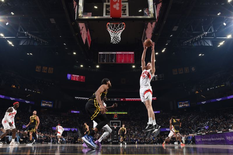 SAN FRANCISCO, CA - JANUARY 7: Jakob Poeltl #19 of the Toronto Raptors grabs a rebound during the game against the Golden State Warriors on January 7, 2024 at Chase Center in San Francisco, California. NOTE TO USER: User expressly acknowledges and agrees that, by downloading and or using this photograph, user is consenting to the terms and conditions of Getty Images License Agreement. Mandatory Copyright Notice: Copyright 2024 NBAE (Photo by Noah Graham/NBAE via Getty Images)