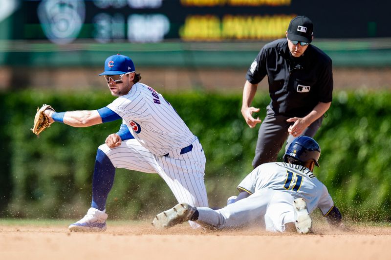 May 3, 2024; Chicago, Illinois, USA; Milwaukee Brewers outfielder Jackson Chourio (11) steals second base against Chicago Cubs second baseman Nico Hoerner (2) during the eight inning at Wrigley Field. Mandatory Credit: Kamil Krzaczynski-USA TODAY Sports