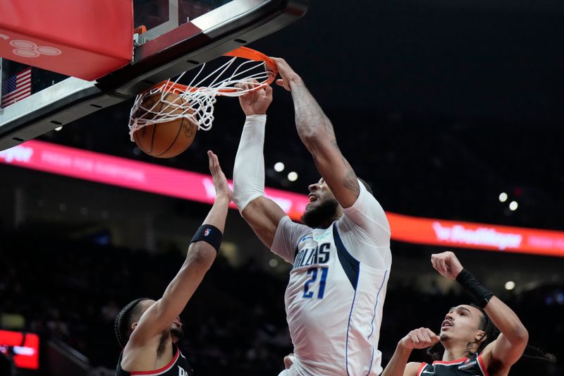 PORTLAND, OREGON - DECEMBER 01: Daniel Gafford #21 of the Dallas Mavericks dunks the ball over Toumani Camara #33 of the Portland Trail Blazers during the first half at Moda Center on December 01, 2024 in Portland, Oregon. NOTE TO USER: User expressly acknowledges and agrees that, by downloading and or using this photograph, User is consenting to the terms and conditions of the Getty Images License Agreement. (Photo by Soobum Im/Getty Images)