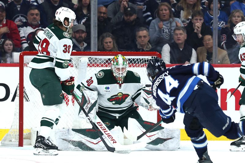 Dec 27, 2025; Winnipeg, Manitoba, CAN; Winnipeg Jets defenseman Josh Morrissey (44) scores on Minnesota Wild goaltender Jesper Wallstedt (30) in the first period at Canada Life Centre. Mandatory Credit: James Carey Lauder-Imagn Images