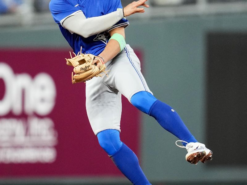 Apr 23, 2024; Kansas City, Missouri, USA; Toronto Blue Jays shortstop Bo Bichette (11) throws to first base during the sixth inning against the Kansas City Royals at Kauffman Stadium. Mandatory Credit: Jay  Biggerstaff-USA TODAY Sports