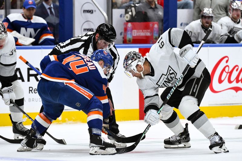 Dec 9, 2023; Elmont, New York, USA; New York Islanders center Jean-Gabriel Pageau (44) faces off against Los Angeles Kings center Trevor Lewis (61) during the first period at UBS Arena. Mandatory Credit: John Jones-USA TODAY Sports