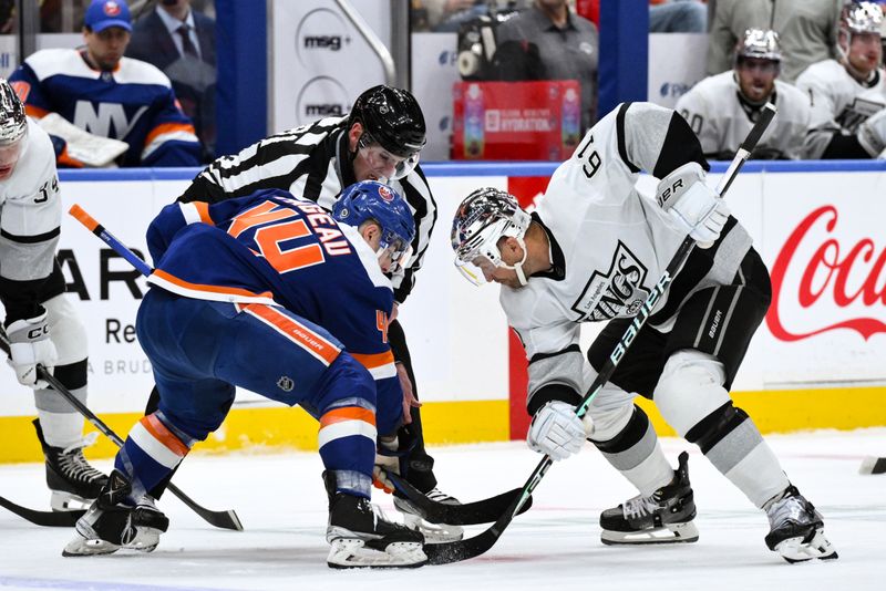 Dec 9, 2023; Elmont, New York, USA; New York Islanders center Jean-Gabriel Pageau (44) faces off against Los Angeles Kings center Trevor Lewis (61) during the first period at UBS Arena. Mandatory Credit: John Jones-USA TODAY Sports