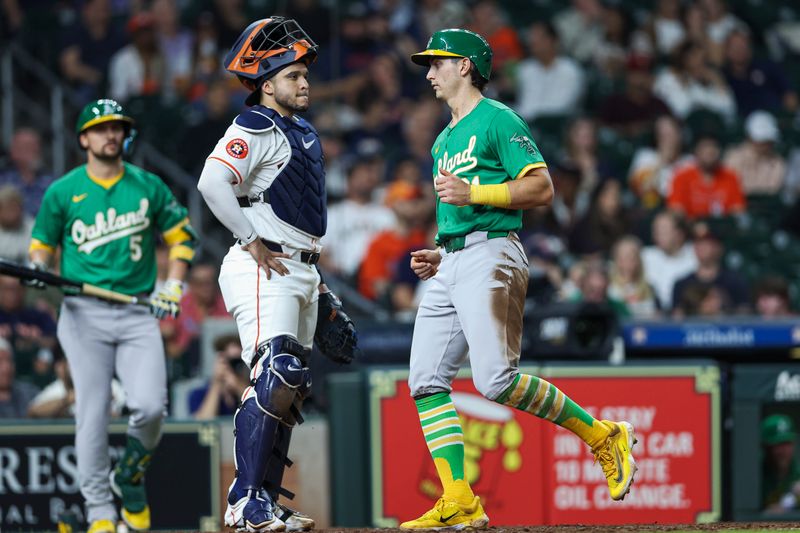 May 16, 2024; Houston, Texas, USA; Oakland Athletics first baseman Tyler Soderstrom (21) scores a run past Houston Astros catcher Yainer Diaz (21) during the seventh inning at Minute Maid Park. Mandatory Credit: Troy Taormina-USA TODAY Sports