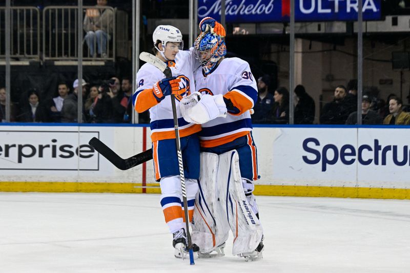 Jan 29, 2026; New York, New York, USA;  New York Islanders defenseman Matthew Schaefer (48) celebrates the 2-1 victory over the New York Rangers with Islanders goaltender Ilya Sorokin (30) during the third period at Madison Square Garden. Mandatory Credit: Dennis Schneidler-Imagn Images