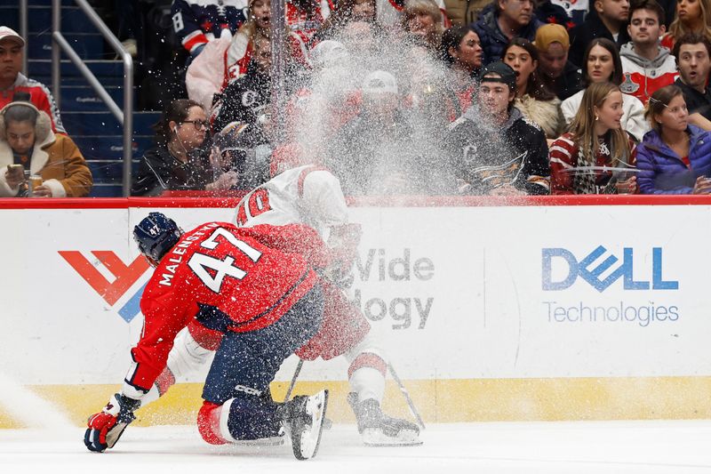 Jan 5, 2024; Washington, District of Columbia, USA; Carolina Hurricanes center Jack Drury (18) and Washington Capitals left wing Beck Malenstyn (47) battles for the puck in the third period at Capital One Arena. Mandatory Credit: Geoff Burke-USA TODAY Sports