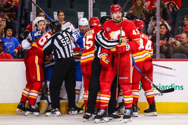Mar 18, 2026; Calgary, Alberta, CAN; Calgary Flames right wing Adam Klapka (43) get into a scrum during the second period against the St. Louis Blues at Scotiabank Saddledome. Mandatory Credit: Sergei Belski-Imagn Images