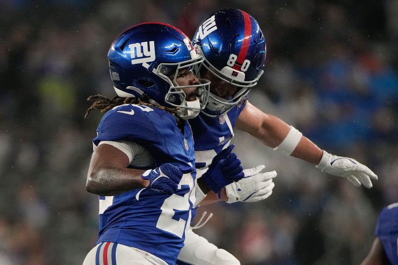 New York Giants running back Eric Gray (20) celebrates with wide receiver Gunner Olszewski (80) after scoring a touchdown against the Detroit Lions during the second quarter of an NFL football game, Thursday, Aug. 8, 2024, in East Rutherford, N.J. (AP Photo/Pamela Smith)