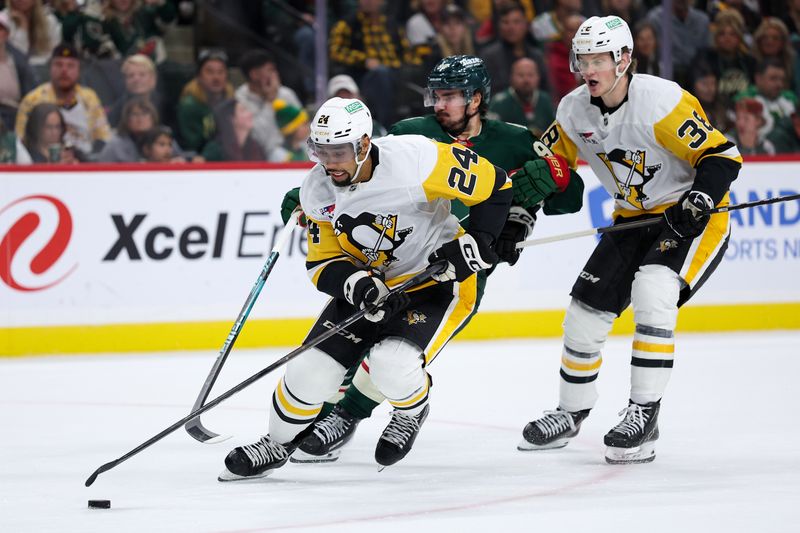Oct 30, 2025; Saint Paul, Minnesota, USA; Pittsburgh Penguins defenseman Mathew Dumba (24) skates with the puck as Minnesota Wild left wing Marcus Johansson (90) defends during the second period at Grand Casino Arena. Mandatory Credit: Matt Krohn-Imagn Images