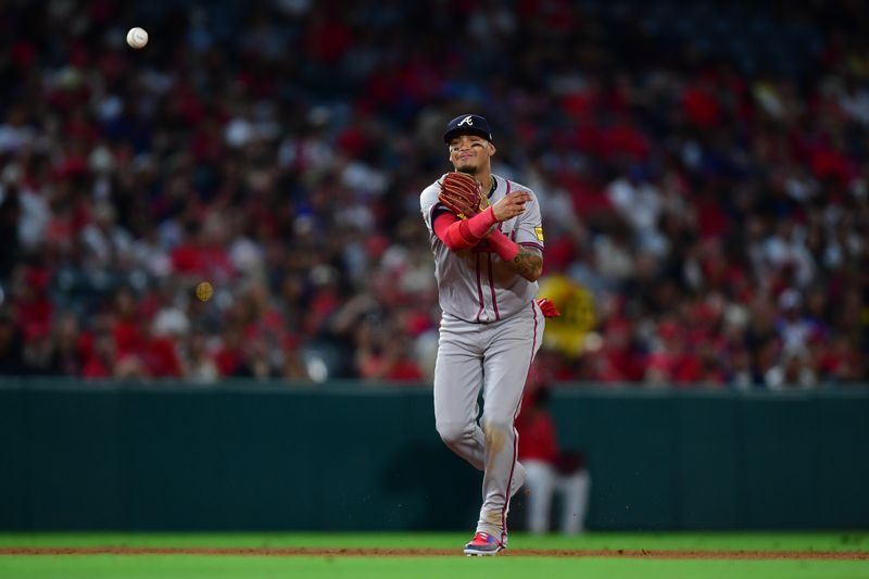 August 16, 2024; Anaheim, California, USA; Atlanta Braves shortstop Orlando Arcia (11) throws to first for the out against Los Angeles Angels second base Brandon Drury (23) during the eighth inning at Angel Stadium. Mandatory Credit: Gary A. Vasquez-USA TODAY Sports