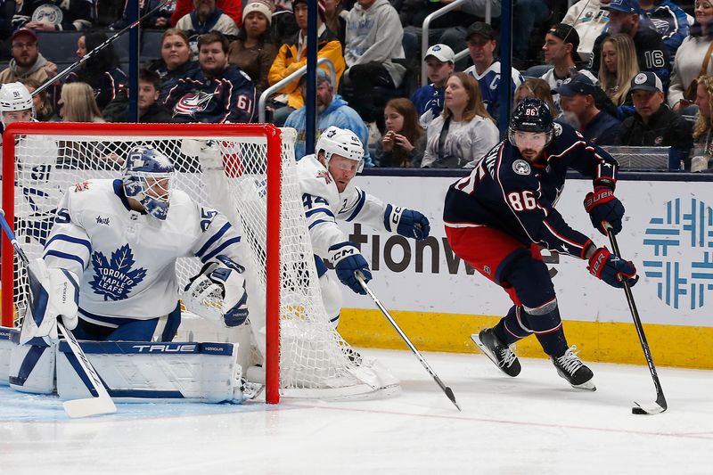 Dec 29, 2023; Columbus, Ohio, USA; Columbus Blue Jackets right wing Kirill Marchenko (86) picks up a loose puck against the Toronto Maple Leafs during the first period at Nationwide Arena. Mandatory Credit: Russell LaBounty-USA TODAY Sports