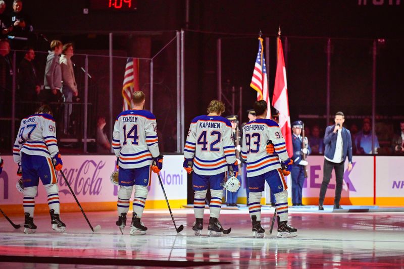 Nov 29, 2024; Salt Lake City, Utah, USA; David Osmond singing the national anthem of Canada between the Utah Hockey Club and the Edmonton Oilers at the Delta Center. Mandatory Credit: Christopher Creveling-Imagn Images