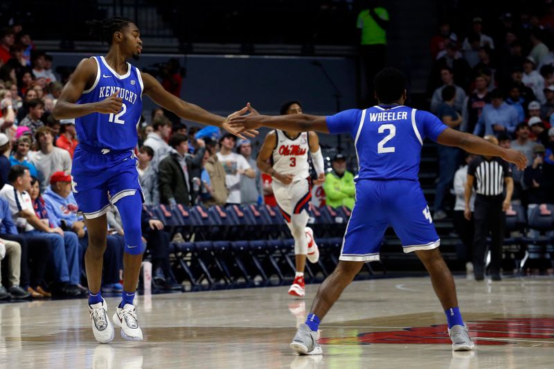 Jan 31, 2023; Oxford, Mississippi, USA; Kentucky Wildcats guard Antonio Reeves (12) celebrates with guard Sahvir Wheeler (2) during the second half against the Mississippi Rebels at The Sandy and John Black Pavilion at Ole Miss. Mandatory Credit: Petre Thomas-USA TODAY Sports