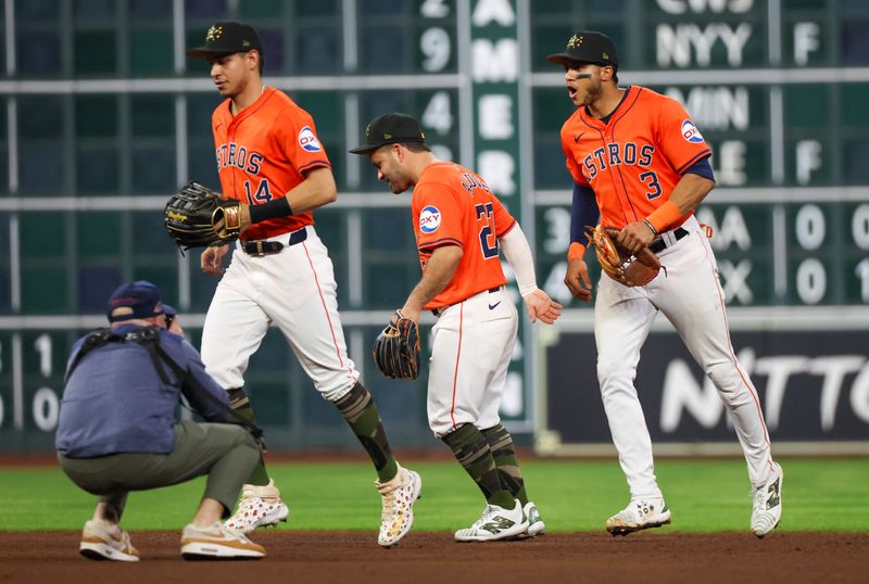 May 17, 2024; Houston, Texas, USA; Houston Astros center fielder Mauricio Dubon (14), second baseman Jose Altuve (27) and  shortstop Jeremy Pena (3) celebrate the win against the Milwaukee Brewers at Minute Maid Park. Mandatory Credit: Thomas Shea-USA TODAY Sports