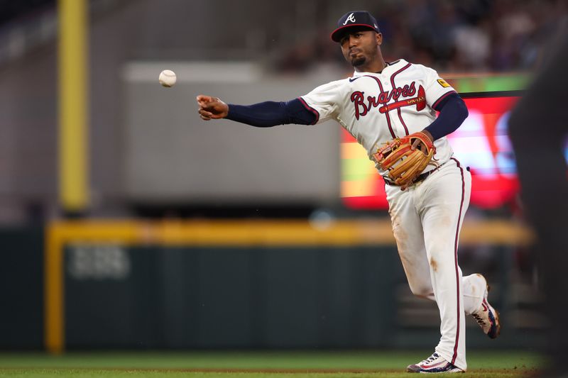 May 8, 2025; Atlanta, Georgia, USA; Atlanta Braves second baseman Ozzie Albies (1) throws a runner out at first against the Cincinnati Reds in the sixth inning at Truist Park. Mandatory Credit: Brett Davis-Imagn Images
