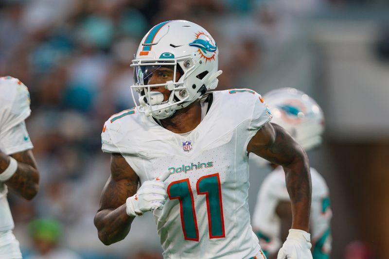 Miami Dolphins wide receiver Cedrick Wilson Jr. (11) in action during an NFL pre-season football game against the Jacksonville Jaguars, Saturday, Aug. 26, 2023, in Jacksonville, Fla. The Jaguars defeated the Dolphins 31-18. (AP Photo/Gary McCullough)