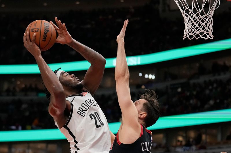 CHICAGO, ILLINOIS - MARCH 13: Noah Clowney #21 of the Brooklyn Nets shoots the ball against Kevin Huerter #13 of the Chicago Bulls during the second quarter at the United Center on March 13, 2025 in Chicago, Illinois. NOTE TO USER: User expressly acknowledges and agrees that, by downloading and or using this photograph, User is consenting to the terms and conditions of the Getty Images License Agreement. (Photo by Patrick McDermott/Getty Images)