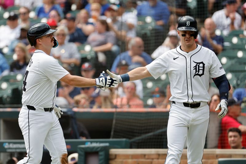 Apr 28, 2024; Detroit, Michigan, USA;  Detroit Tigers catcher Jake Rogers (34) celebrates with outfielder Mark Canha (21) after scoring in the second inning against the Kansas City Royals at Comerica Park. Mandatory Credit: Rick Osentoski-USA TODAY Sports