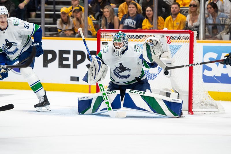 May 3, 2024; Nashville, Tennessee, USA; Vancouver Canucks goalkeeper Vancouver Canucks goalie Arturs Silovs (31) blocks the puck against the Nashville Predators during the third period in game six of the first round of the 2024 Stanley Cup Playoffs at Bridgestone Arena. Mandatory Credit: Steve Roberts-USA TODAY Sports